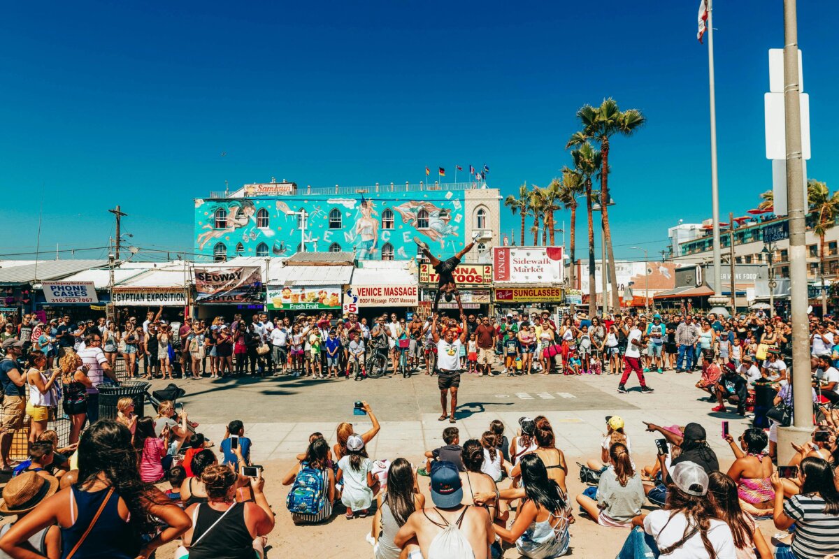 Street performers surrounded by a crowd at the Venice Beach Boardwalk aka Ocean Front Walk in Los Angeles, California