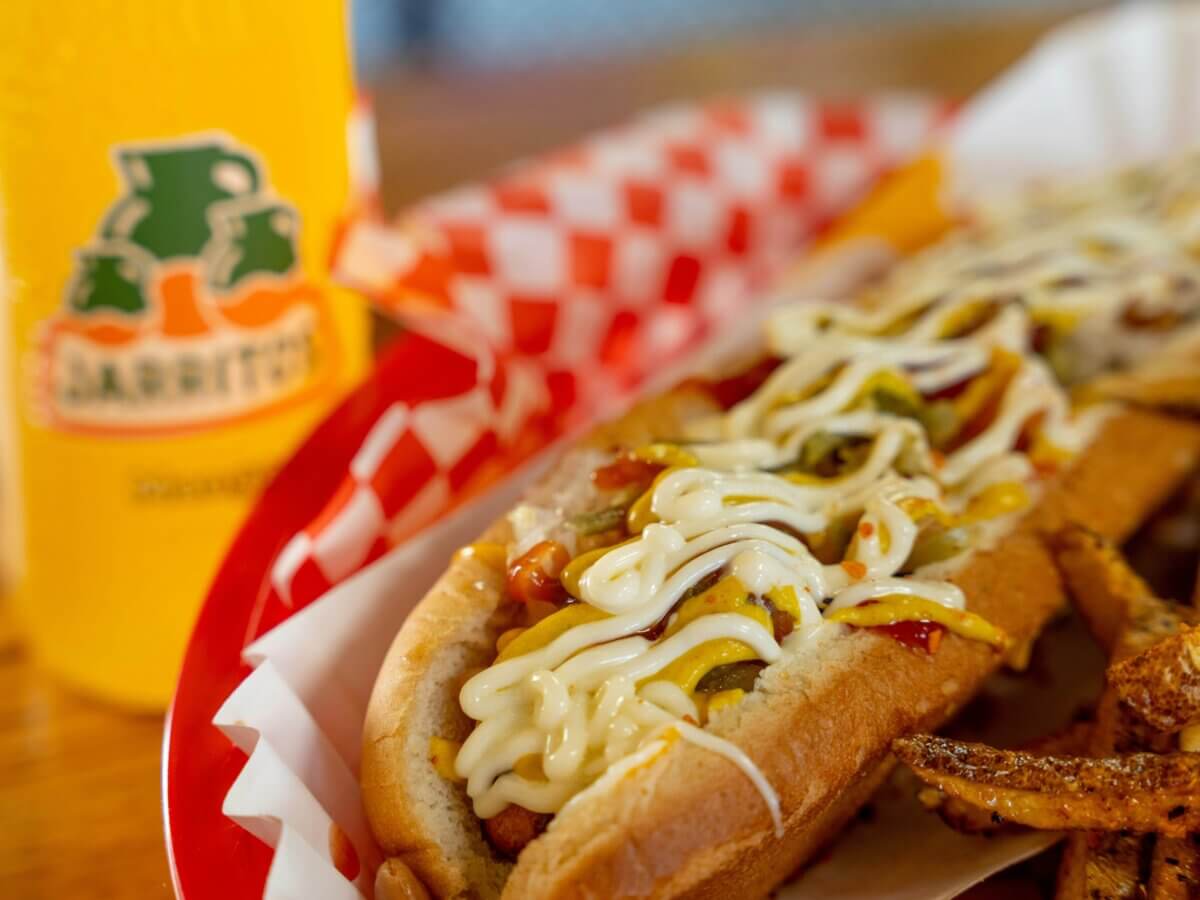 Sonora dog on a tray with a Mexican soda